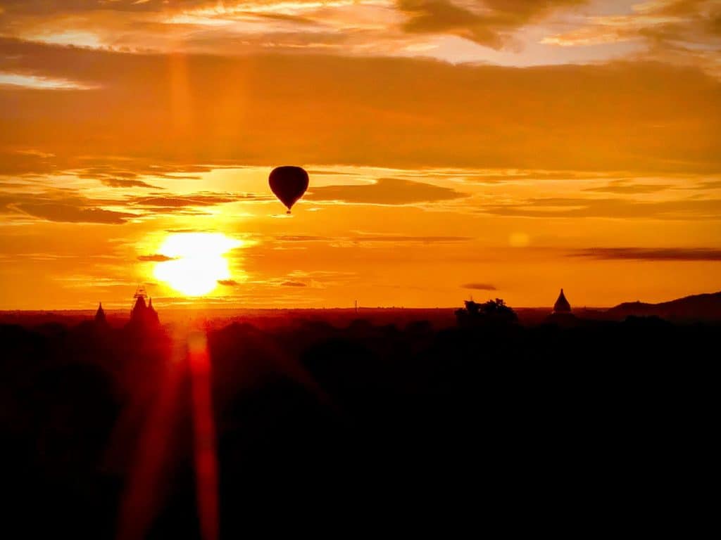 Hot Air Balloon Over Temple at Sunset